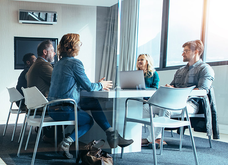 People sitting at a meeting table in a board room