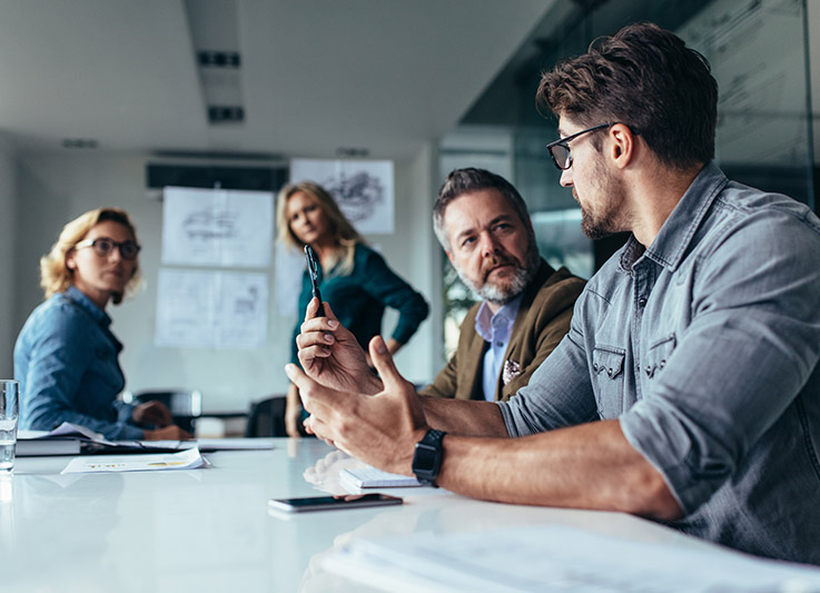 People discussing plans in a meeting room